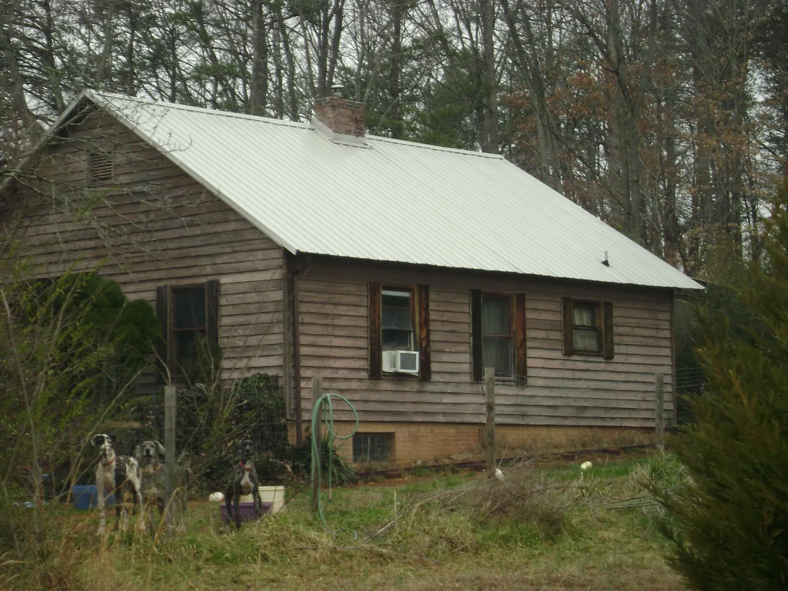 White metal roof on an old wood sided farmhouse, from a Asphalt Shingle Roof Repair job in Norway